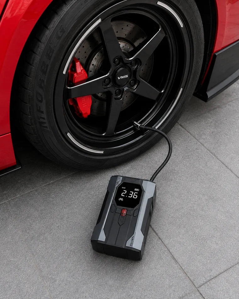 Portable inflator connected to a car tire for a pressure top-up
